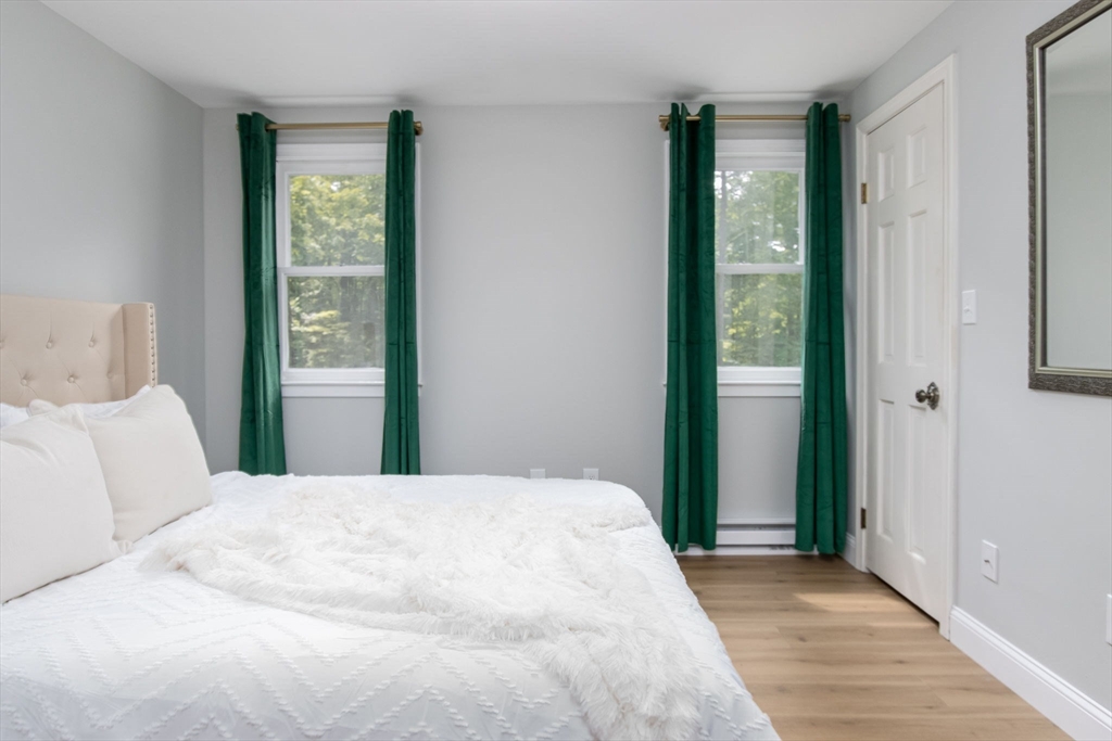 420 Pepperell Road Groton, MA 01450 - Photo 17 of 26 a bedroom with a large bed and a window