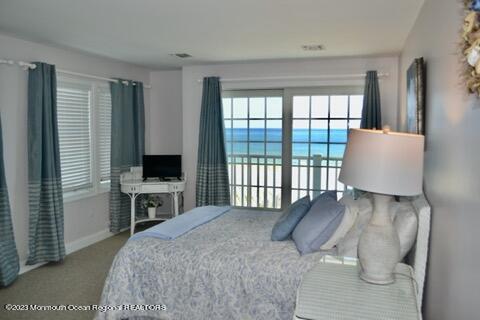 2 Bridge Avenue Bay Head, NJ 08742 - Photo 24 of 24 a spacious bedroom with a bed and a flat tv screen next to a window