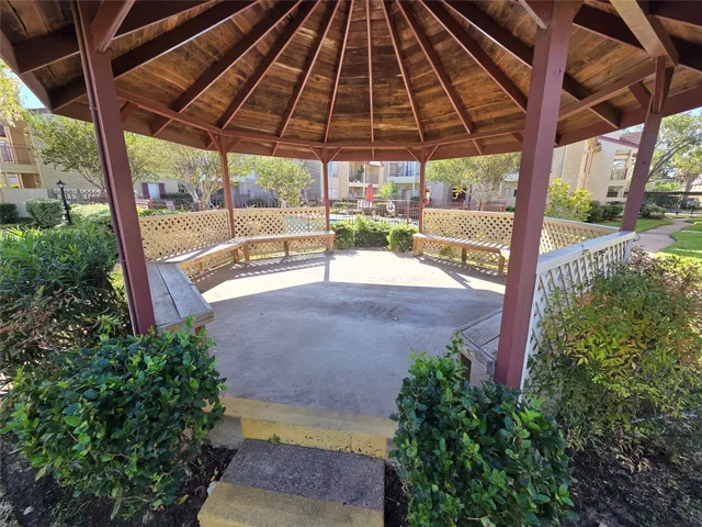 a view of a white house with a swimming pool and a yard