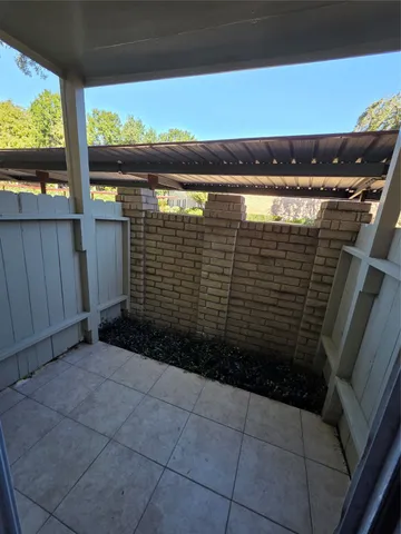 a view of empty room with wooden floor and fireplace