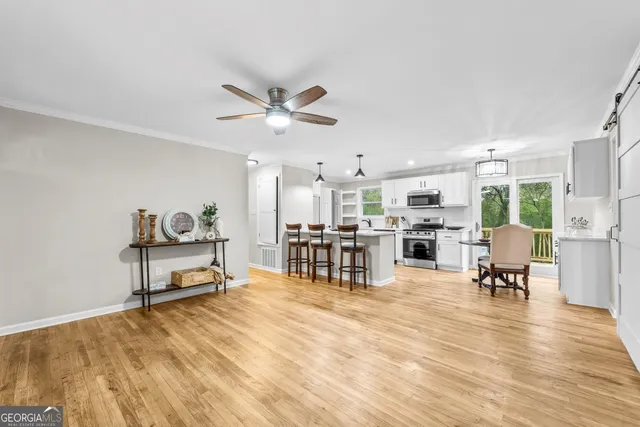 a living room with furniture and kitchen view