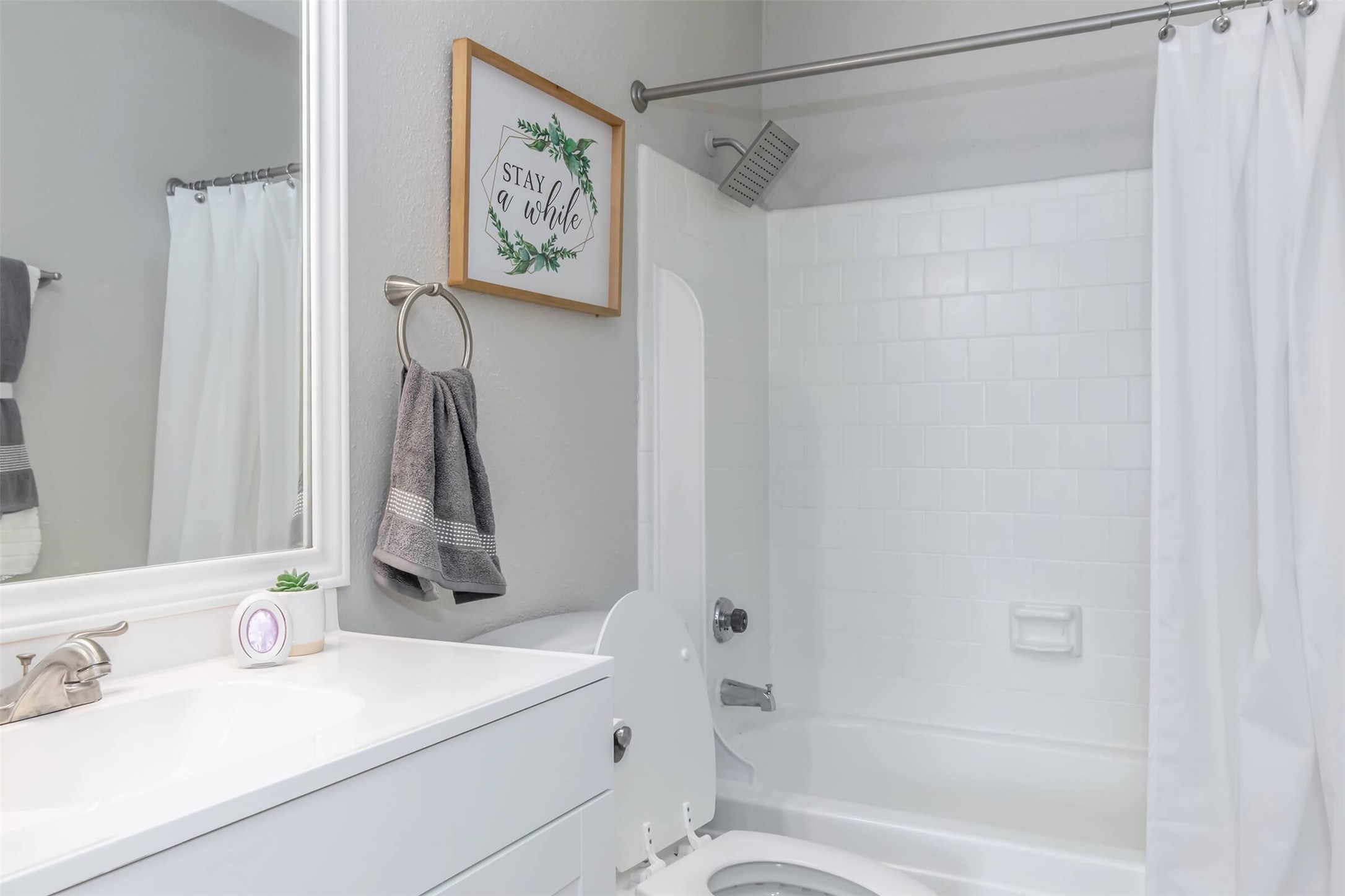 18001 Cypress Trace Road, Unit 1803 Houston, TX 77090 - Photo 11 of 32 a bathroom with a sink and a mirror
