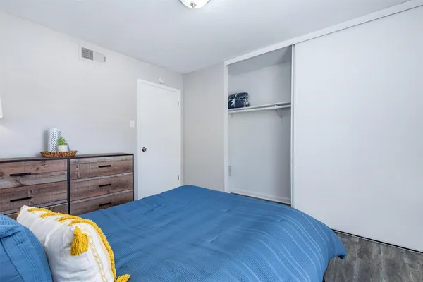 a bed room with a bed and a dresser