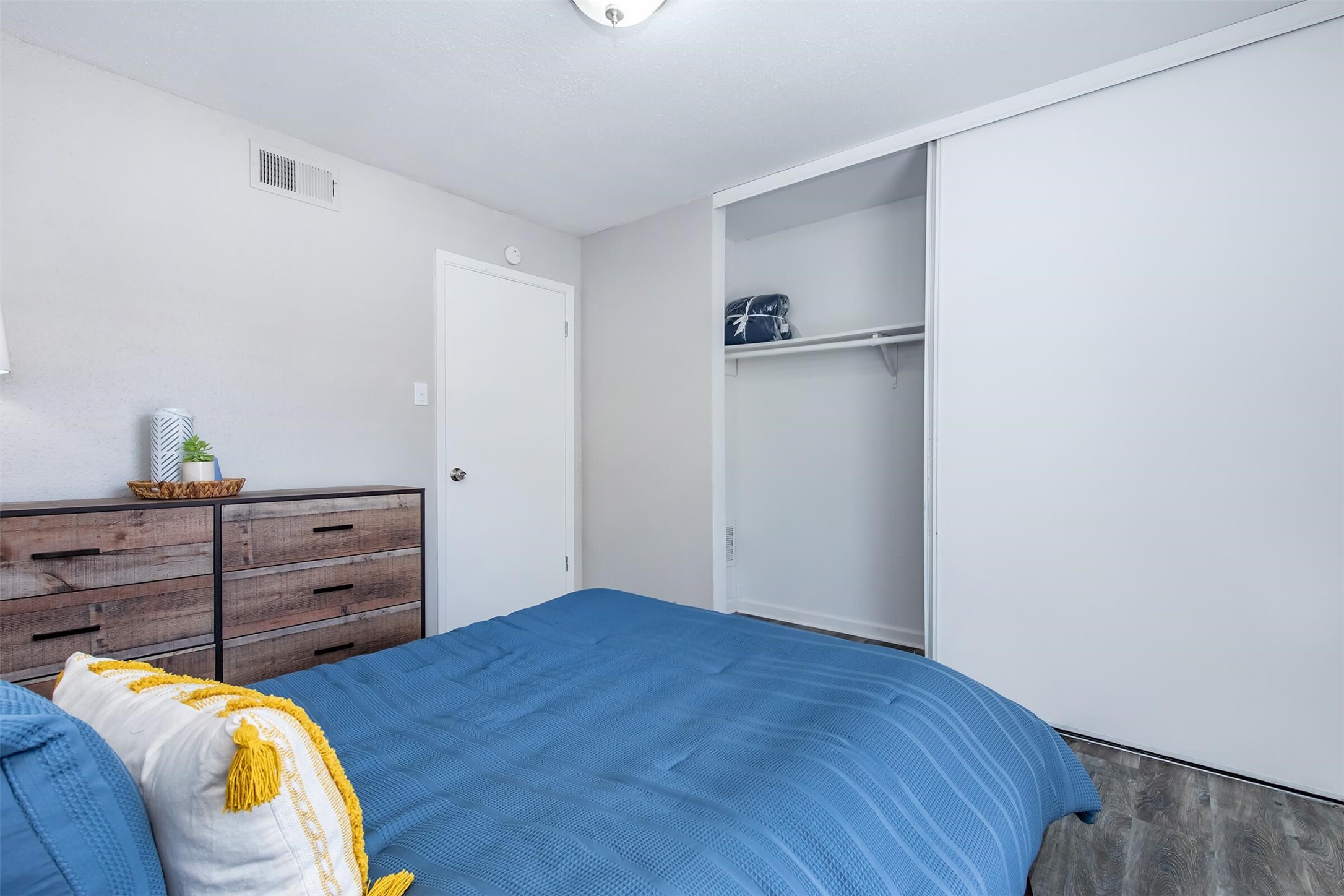 18001 Cypress Trace Road, Unit 1803 Houston, TX 77090 - Photo 14 of 32 a bed room with a bed and a dresser