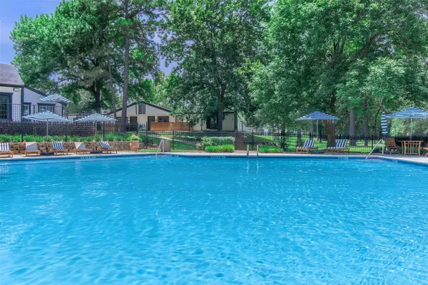 a house view with swimming pool in front of it