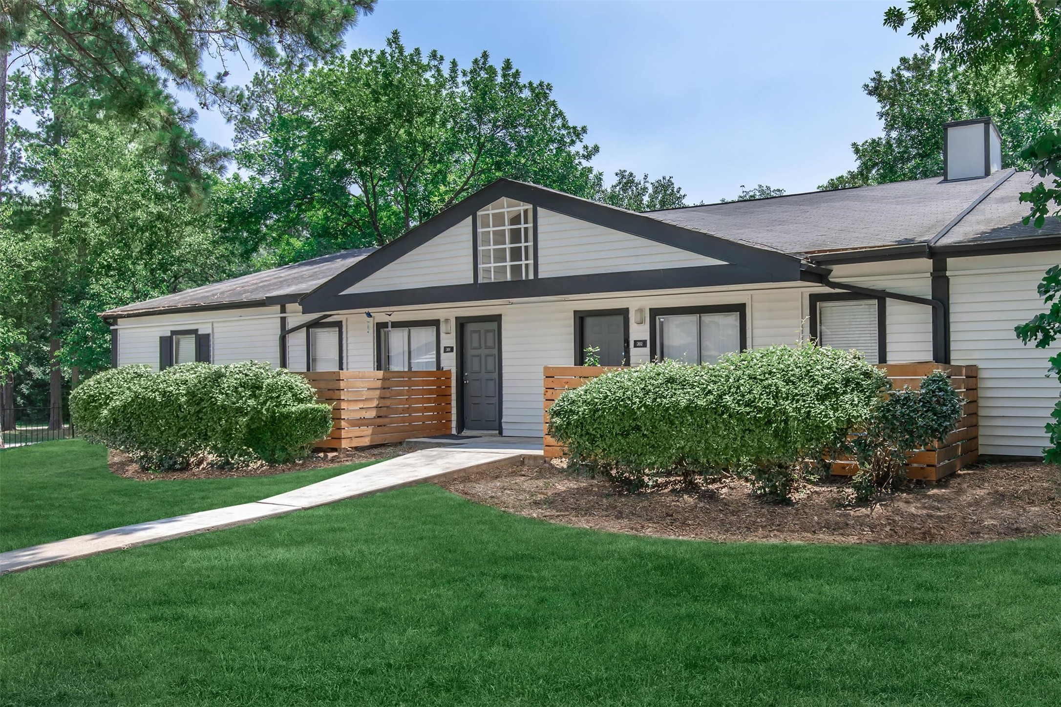 18001 Cypress Trace Road, Unit 1803 Houston, TX 77090 - Photo 31 of 32 a front view of a house with a yard and green space