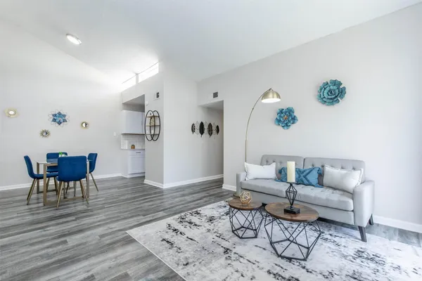 a living room with furniture and wooden floor