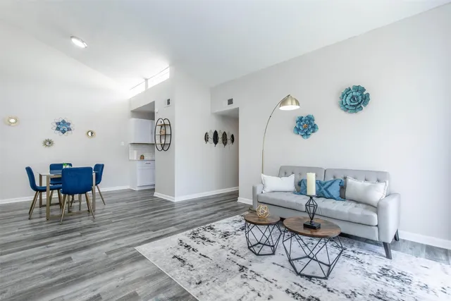 a living room with furniture and wooden floor