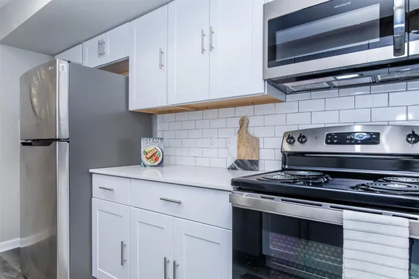 a kitchen with stainless steel appliances granite countertop a stove and a refrigerator