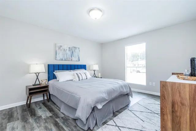 a bedroom with a bed and a window