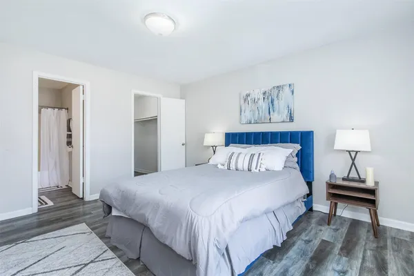 a bedroom with a bed and a night stand