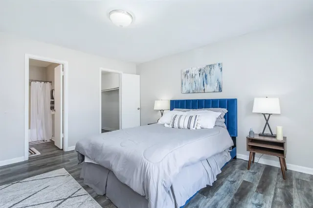 a bedroom with a bed and a night stand