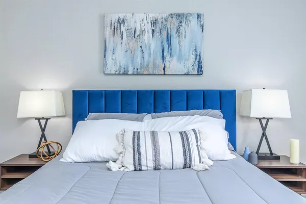 a bed room with a bed and a lamp