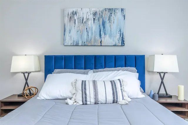 a bed room with a bed and a lamp