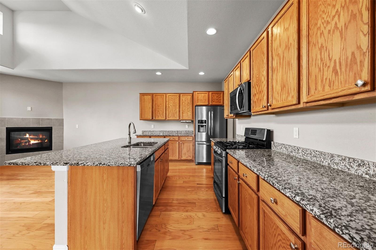 1354 Promontory Bluff View Colorado Springs, CO 80921 - Photo 14 of 45 a kitchen with granite countertop stainless steel appliances a sink a counter top space and cabinets