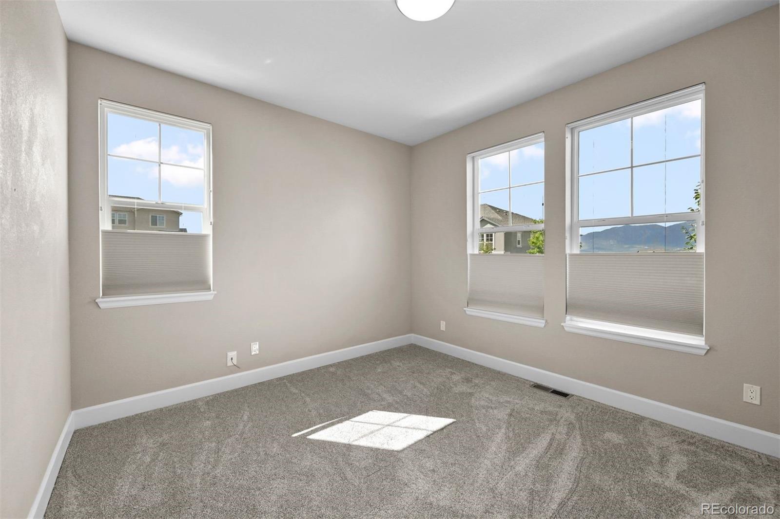 1354 Promontory Bluff View Colorado Springs, CO 80921 - Photo 20 of 45 an empty room with windows