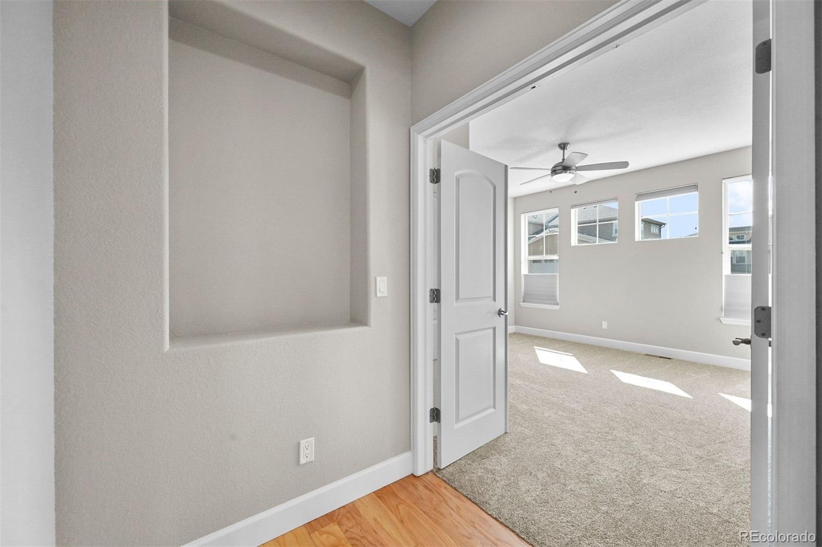 1354 Promontory Bluff View Colorado Springs, CO 80921 - Photo 22 of 45 an empty room with wooden floor and windows