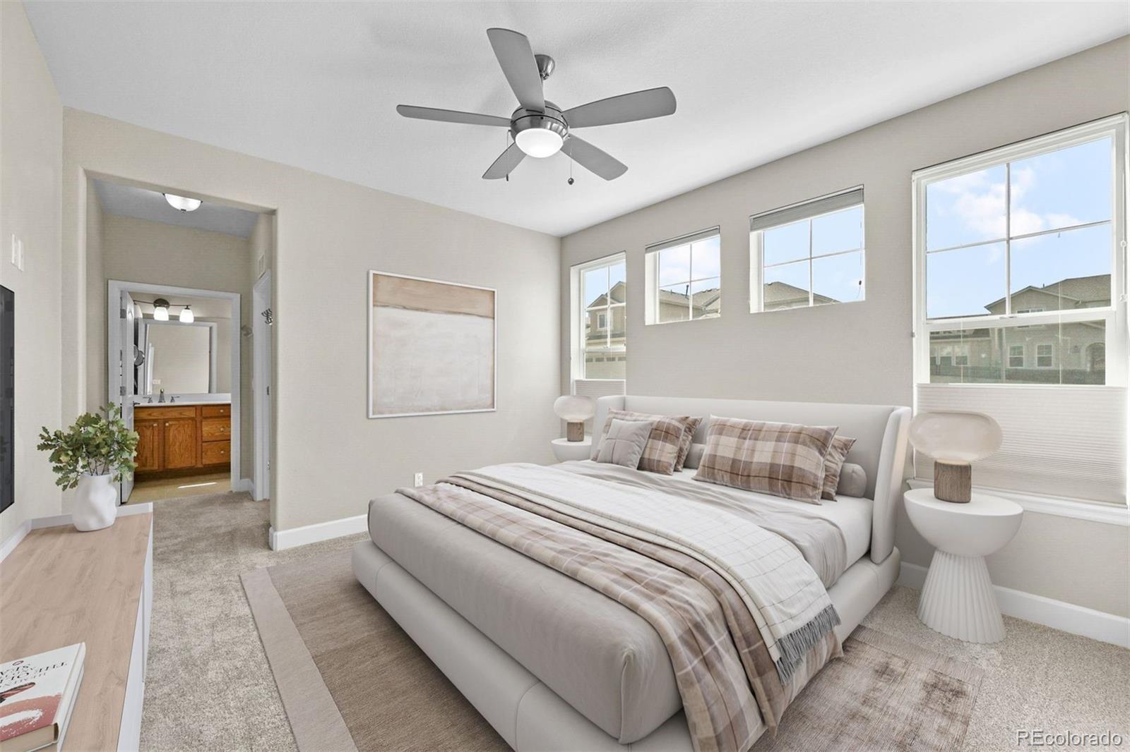 1354 Promontory Bluff View Colorado Springs, CO 80921 - Photo 5 of 45 a bedroom with a large bed couch and two windows