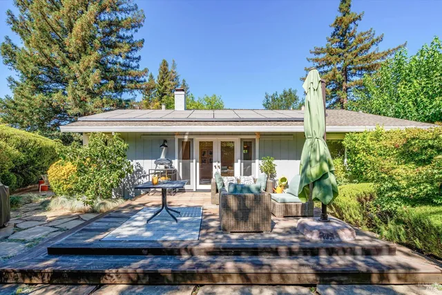 a view of a house with sitting area and garden