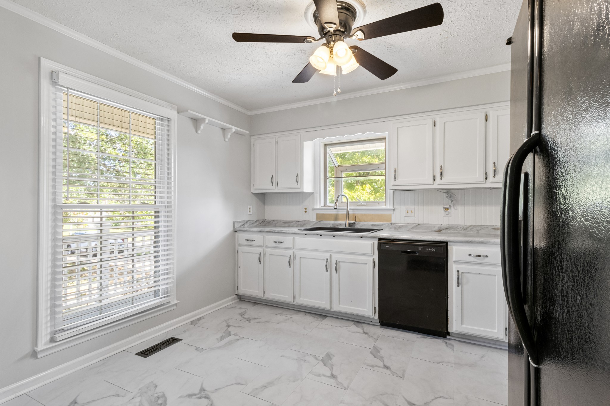 1980 Bradbury Road Adams, TN 37010 - Photo 8 of 24 a kitchen with granite countertop a stove sink and refrigerator
