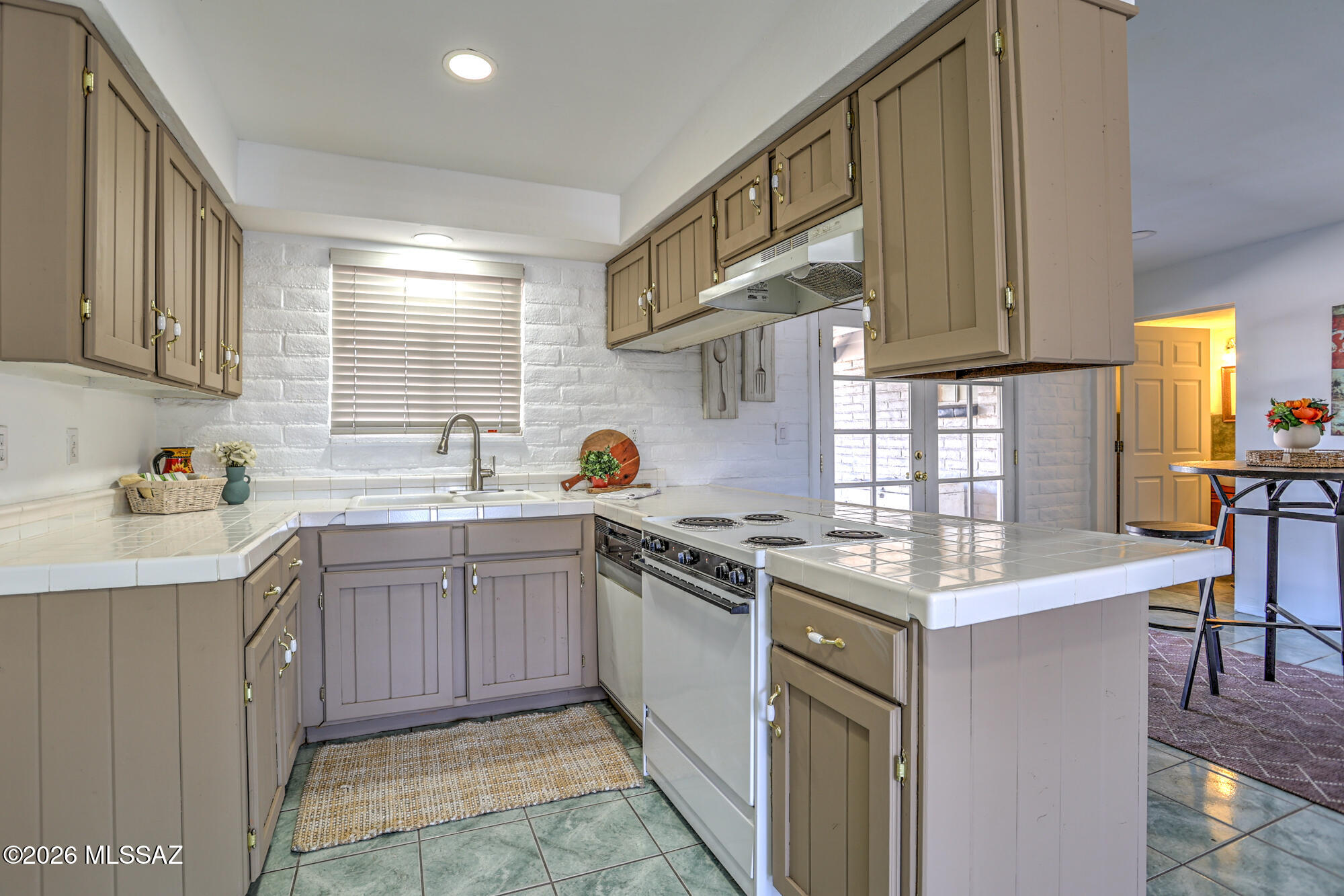 4400 West Ina Road Tucson, AZ 85741 - Photo 16 of 43 a kitchen with stainless steel appliances granite countertop a sink stove and cabinets