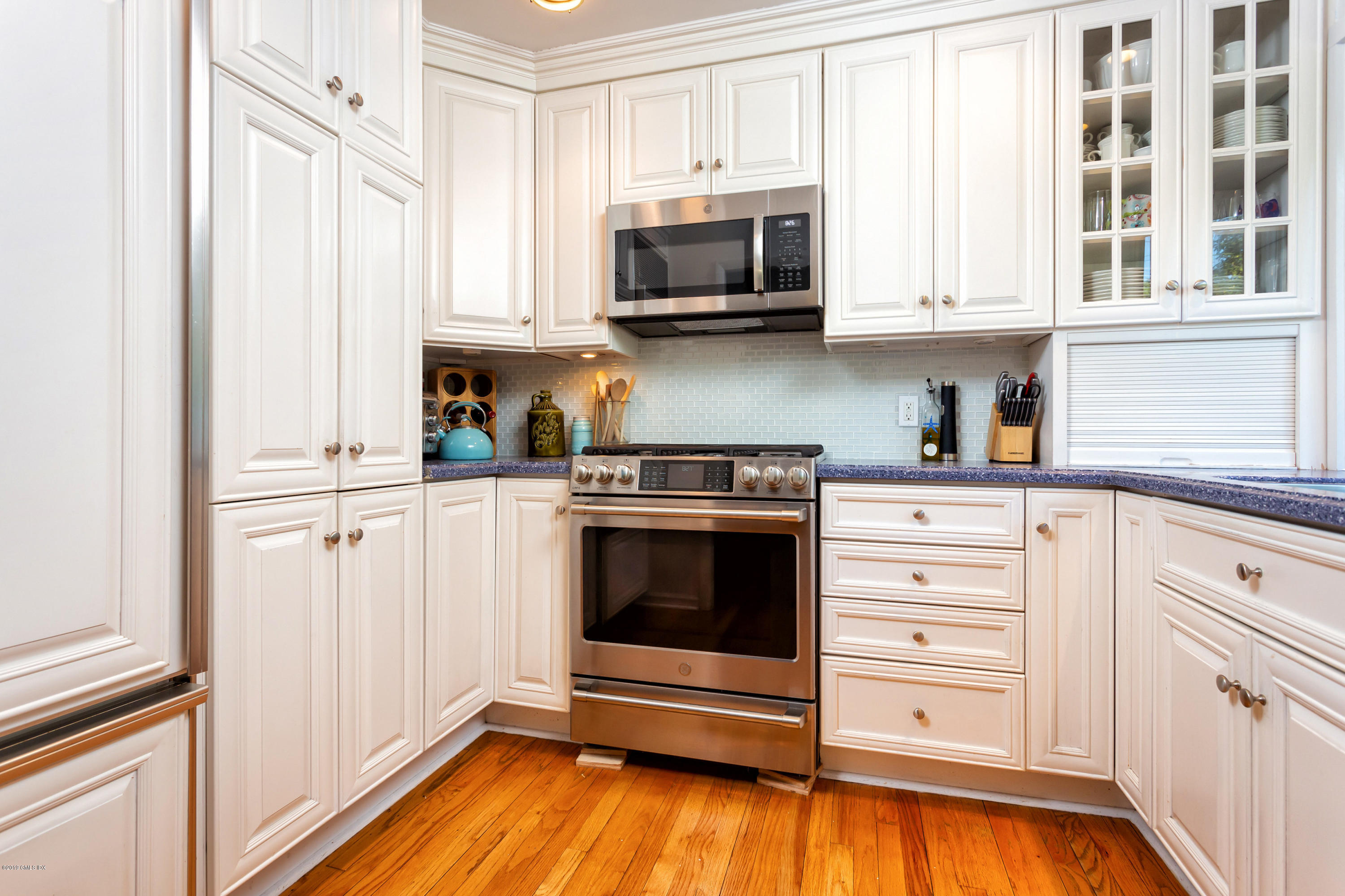 12 Mary Lane Riverside, CT 06878 - Photo 12 of 25 a kitchen with stainless steel appliances a stove microwave and cabinets