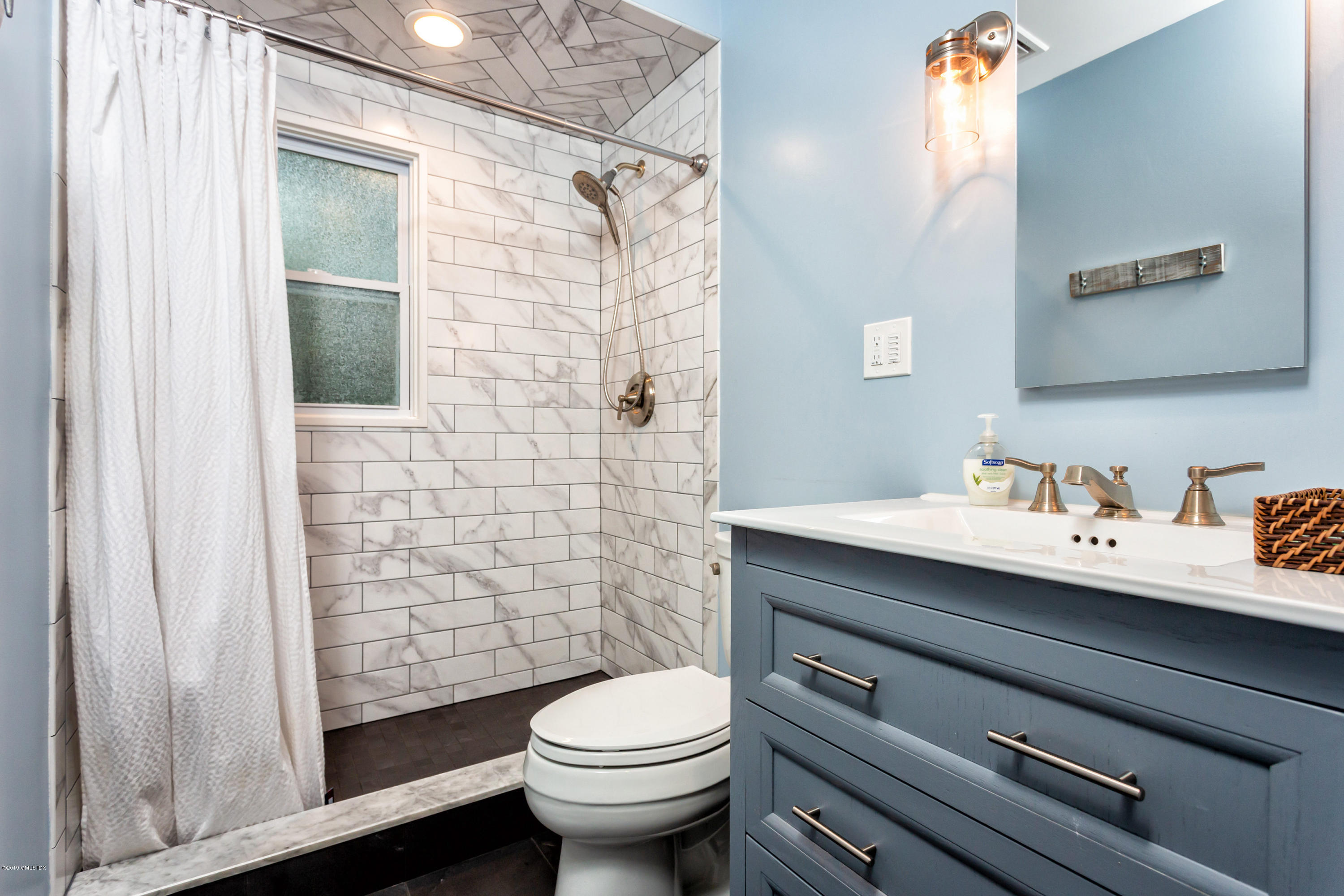 12 Mary Lane Riverside, CT 06878 - Photo 13 of 25 a bathroom with a sink a toilet and shower