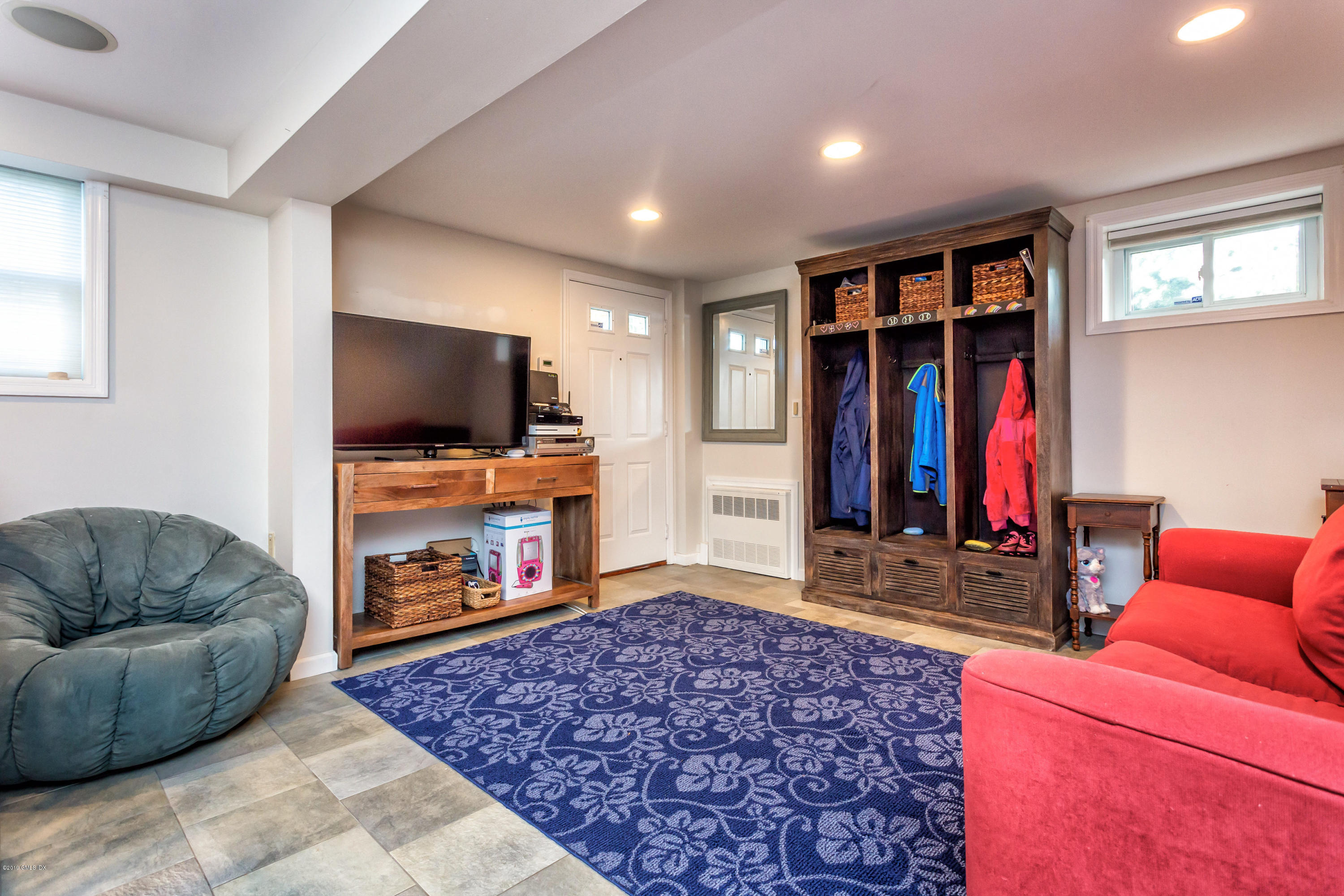 12 Mary Lane Riverside, CT 06878 - Photo 17 of 25 a living room with furniture a flat screen tv and a fireplace