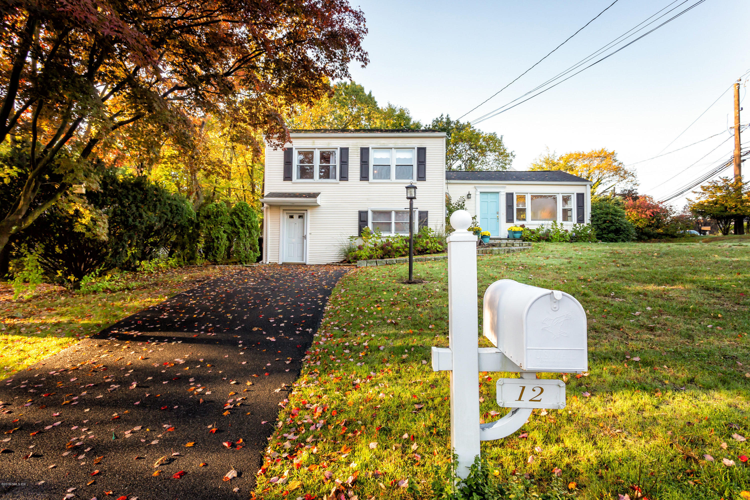 12 Mary Lane Riverside, CT 06878 - Photo 2 of 25 a front view of a house with a yard