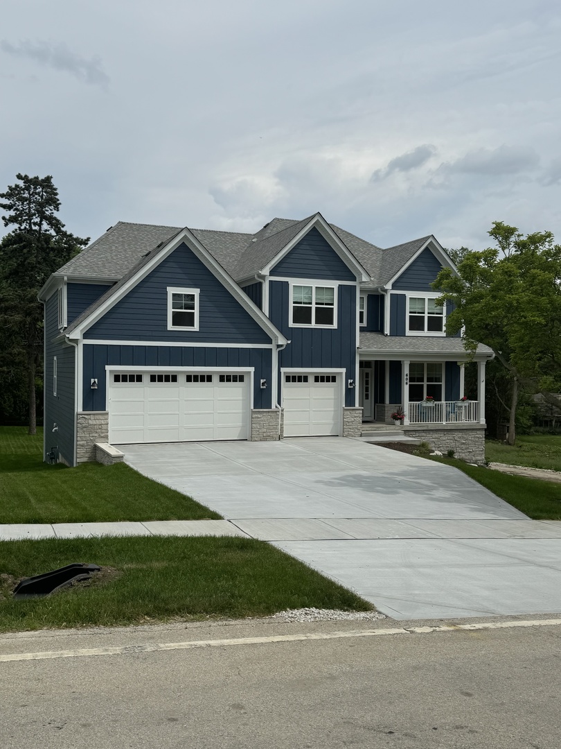 123 West Benton Street Oswego, IL 60543 - Photo 16 of 16 a front view of a house with a yard
