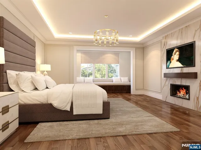 a spacious bedroom with a bed and a chandelier