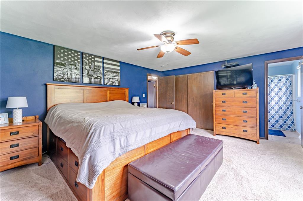 321 Eighmy Road Pittsburgh, PA 15239 - Photo 16 of 24 a bedroom with a bed and a chandelier