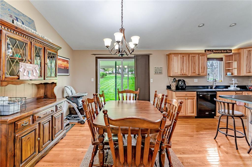 321 Eighmy Road Pittsburgh, PA 15239 - Photo 6 of 24 a view of a dining room with furniture a chandelier and wooden floor