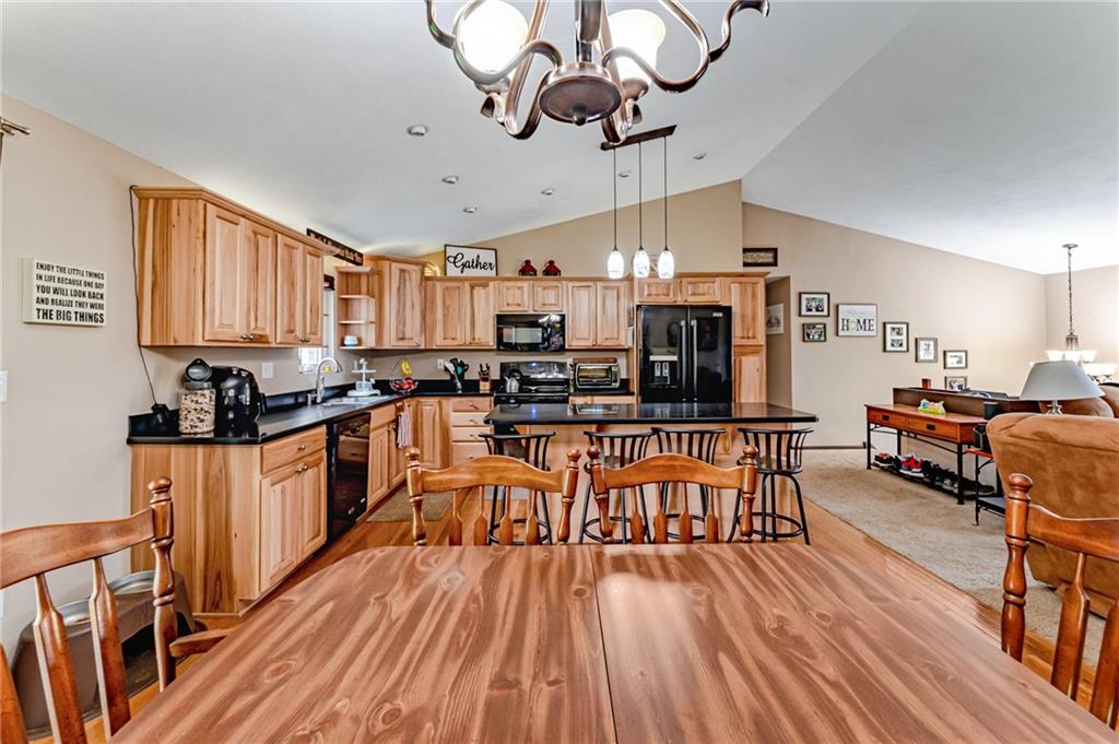 321 Eighmy Road Pittsburgh, PA 15239 - Photo 8 of 24 a kitchen with stainless steel appliances wooden floors stove and white cabinets