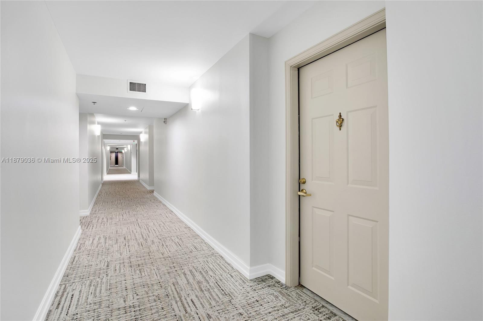 2665 Southwest 37th Avenue, Unit 512 Miami, FL 33133 - Photo 16 of 17 a view of a hallway view with wooden floor and staircase