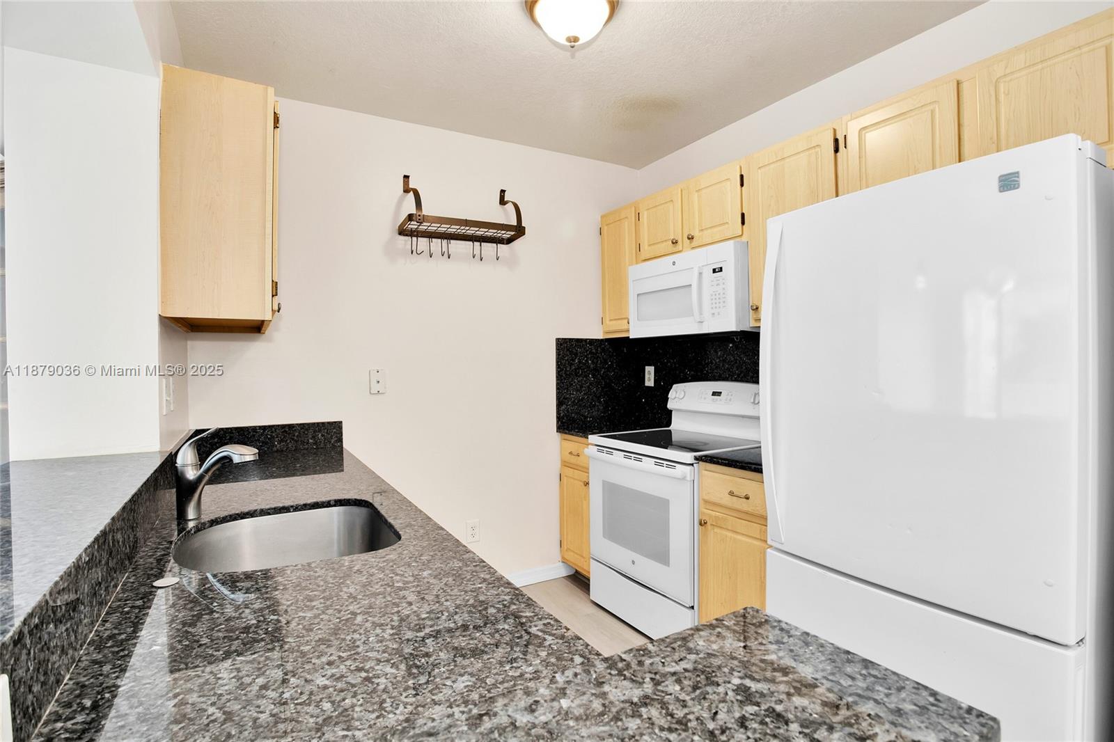 2665 Southwest 37th Avenue, Unit 512 Miami, FL 33133 - Photo 3 of 17 a kitchen with stainless steel appliances a sink a stove a refrigerator a counter top space and cabinets