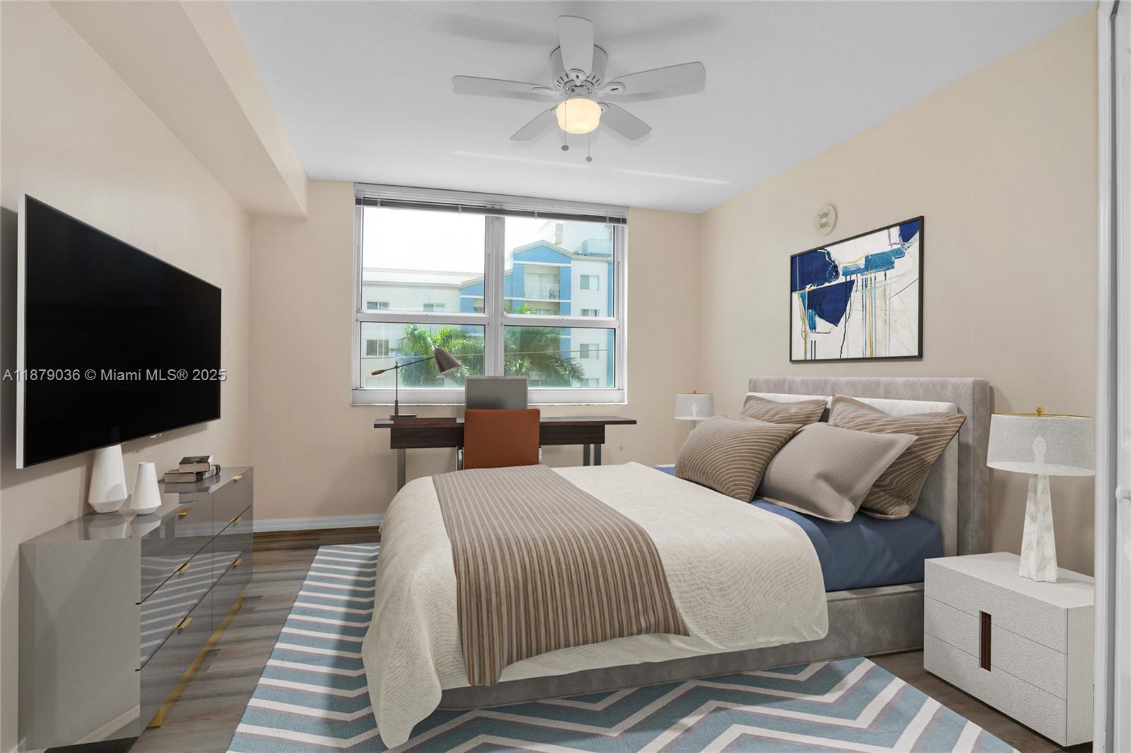 2665 Southwest 37th Avenue, Unit 512 Miami, FL 33133 - Photo 6 of 17 a bedroom with two beds and a flat screen tv