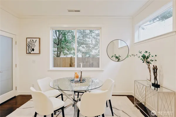 a view of a dining room with furniture window and wooden floor
