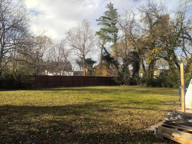 a view of a big yard with an trees