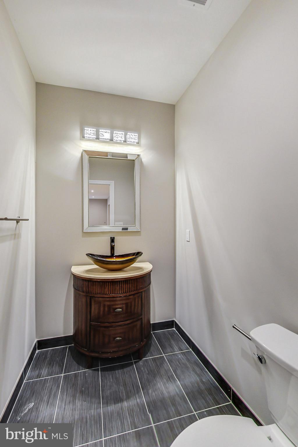 3104 Sleepy Hollow Road Falls Church, VA 22042 - Photo 72 of 89 a bathroom with a sink a toilet and a mirror
