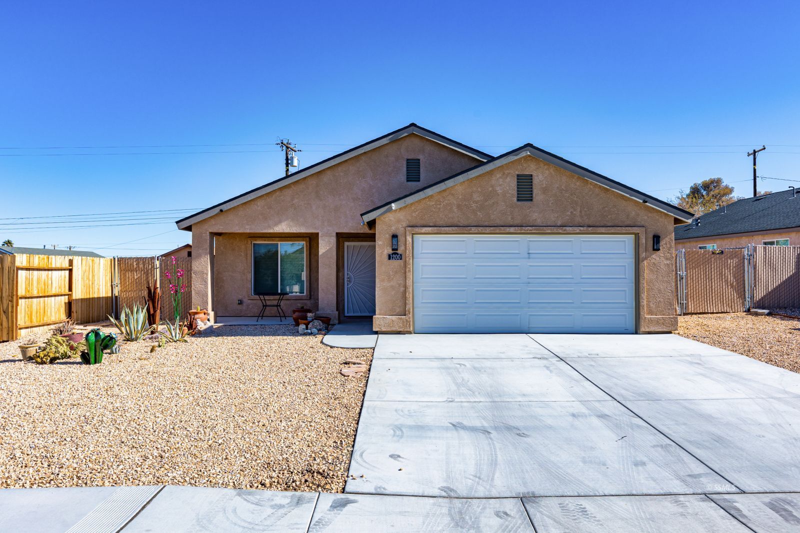 1200 South McCall Street Ridgecrest, CA 93555 - Photo 1 of 30 a front view of a house with a yard outdoor seating and garage