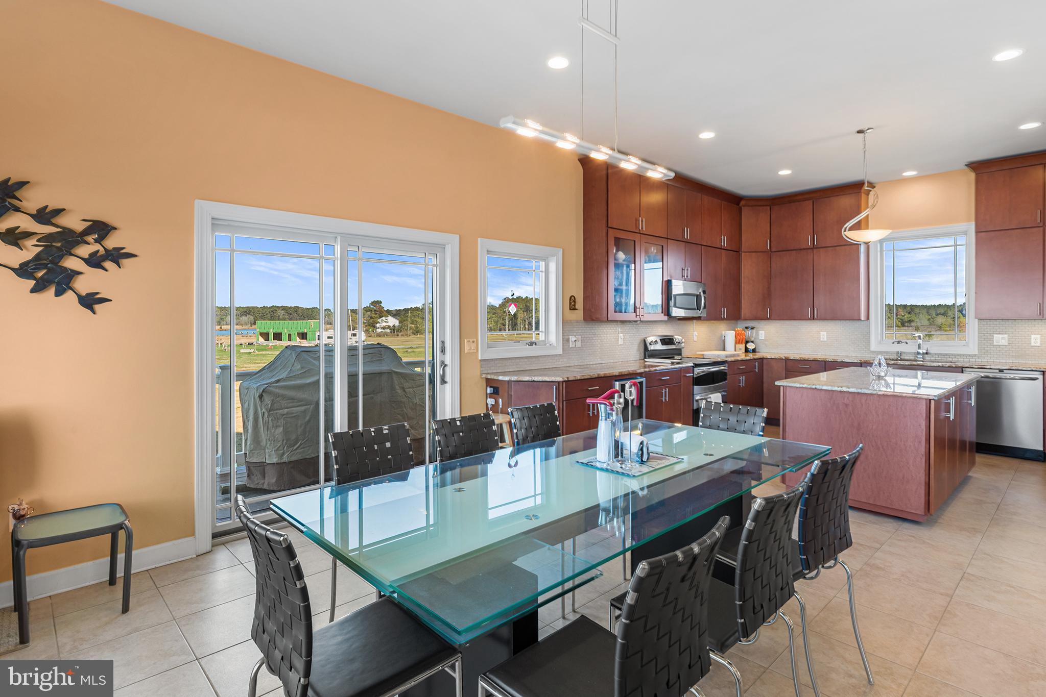 1252 Old Madison Road Madison, MD 21648 - Photo 17 of 55 a kitchen with stainless steel appliances granite countertop a stove top oven a sink a dining table and chairs