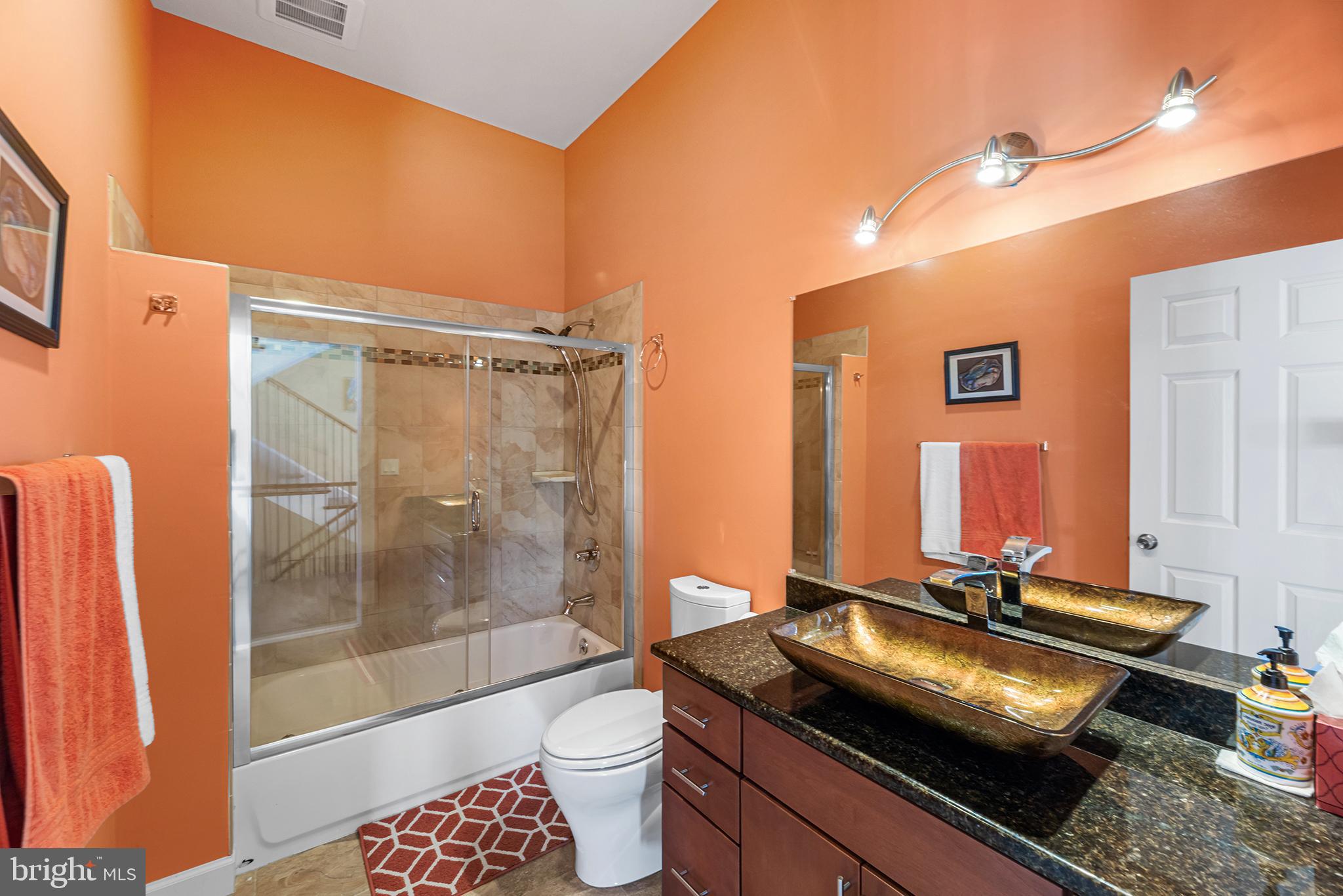 1252 Old Madison Road Madison, MD 21648 - Photo 26 of 55 a bathroom with a granite countertop sink a toilet a mirror and shower