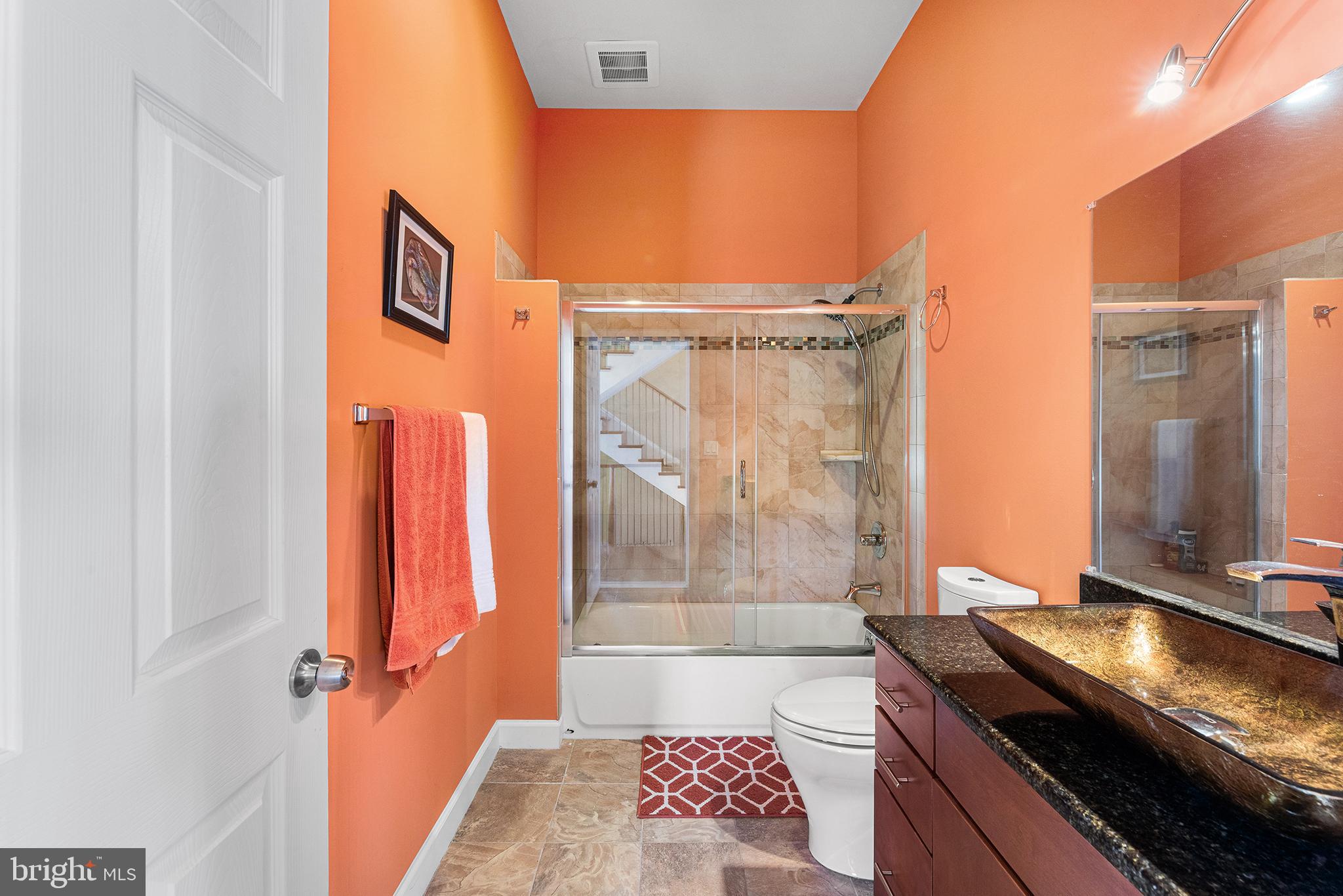 1252 Old Madison Road Madison, MD 21648 - Photo 27 of 55 a bathroom with a granite countertop sink a mirror and shower