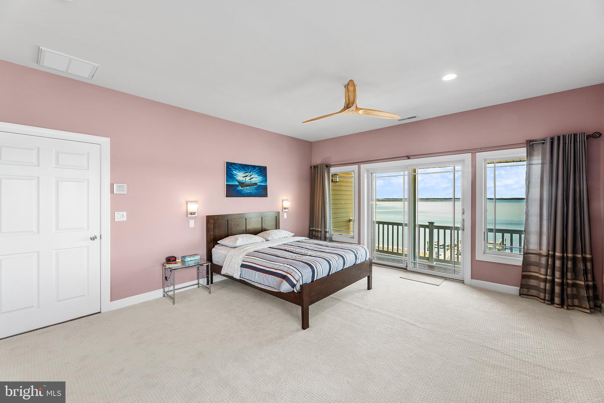 1252 Old Madison Road Madison, MD 21648 - Photo 33 of 55 a spacious bedroom with a bed and a ceiling fan