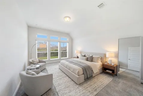 a bedroom with a bed and a couch