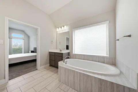 a bathroom with a bathtub and a sink