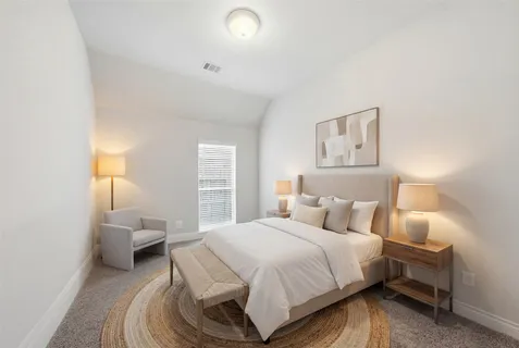 a bedroom with a bed and a lamp