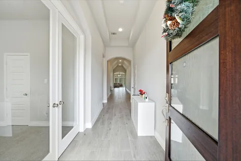 a view of a hallway with wooden floor and staircase