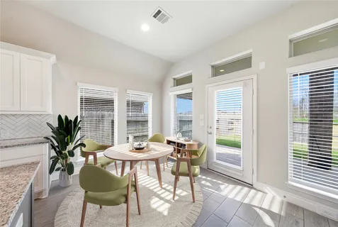 a dining room with furniture and window